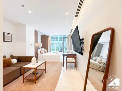 a living room with a couch and a mirror at Sterling East Prime Location ST in Business Bay in Dubai