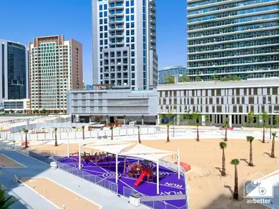 a playground in the middle of a city with tall buildings at Sterling East Prime Location ST in Business Bay in Dubai