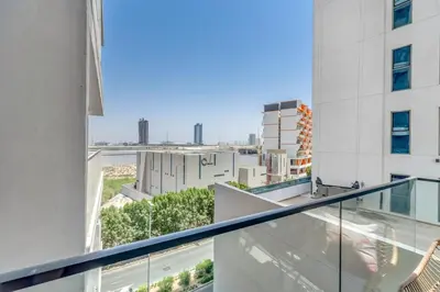 an apartment balcony with a view of a city at Waves - Rustic Chic 1 BR Retreat in Vibrant JVC in Dubai