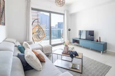 a living room with a couch and a tv at Frank Poretr - AG Tower in Dubai
