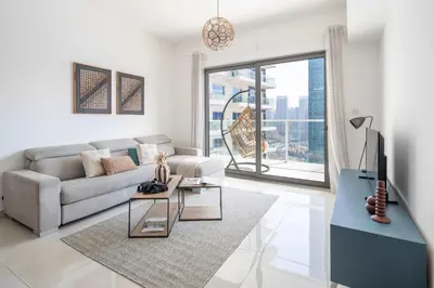 a living room with a couch and a tv at Frank Poretr - AG Tower in Dubai