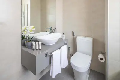 a bathroom with a white sink and a toilet at Frank Poretr - AG Tower in Dubai
