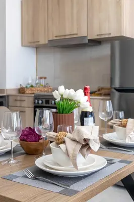 a table with plates and wine glasses on it at Frank Poretr - AG Tower in Dubai