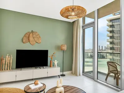 a living room with a tv and a large window at Stunning Central 2BR Lagoon View & Private Beach in Dubai