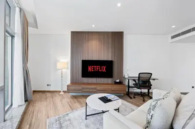 a living room with a couch and a tv at YOUR STAY CORPORATE RESIDENCES DIFC Sky Gardens in Dubai