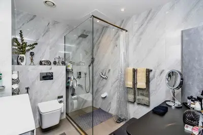 a bathroom with a shower and a toilet and a sink at Ocean Heights Dubai Marina Ocean View in Dubai