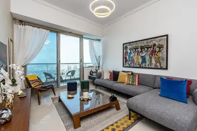 a living room with a couch and a table at Ocean Heights Dubai Marina Ocean View in Dubai