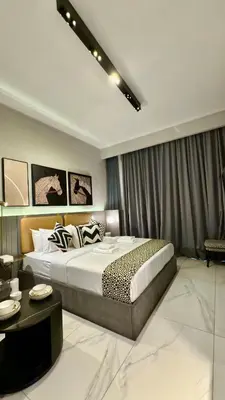 a bedroom with a king sized bed and a table at Burj Khalifa View 5 Mins Walk to Dubai Mall in Dubai