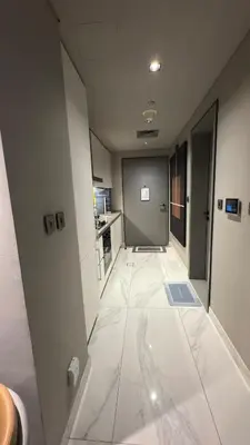 a large hallway with white tile flooring in a building at Burj Khalifa View 5 Mins Walk to Dubai Mall in Dubai