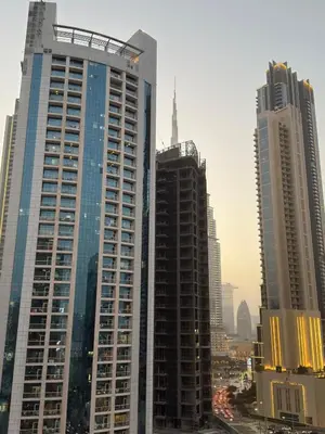 a group of tall buildings in a city at Burj Khalifa View 5 Mins Walk to Dubai Mall in Dubai