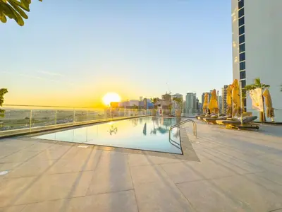 a swimming pool on a building next to the ocean at Luxurious Apt 2BR Stunning Full Burj Khalifa view in Dubai