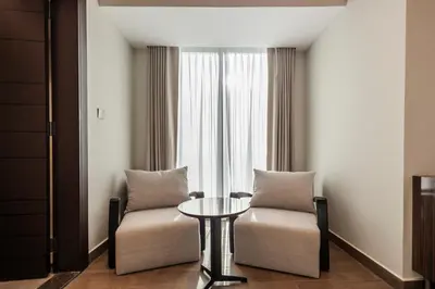 a room with two chairs and a table and a window at Luxurious Apt 2BR Stunning Full Burj Khalifa view in Dubai