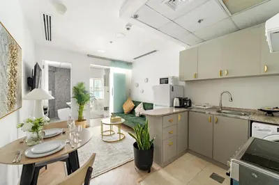 a kitchen and living room with a table and a dining room at Bright Studio in Dubai Gate 2 in Dubai