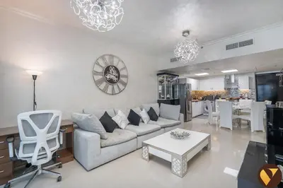 a living room with a couch and a table at Vogue DIFC Damac Park Tower near Museum of The Future, One Bedroom Apartment with Balcony, City Skyline and Museum of The Future View, Access to all Amenities in Dubai