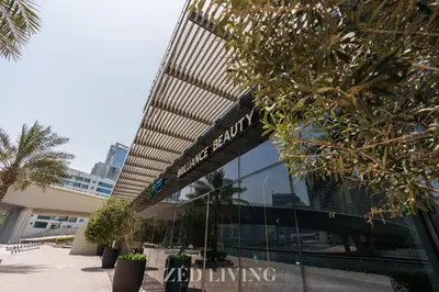 a building with a sign on the side of it at Emaar 5242 - Stunning Sea View Stay in Prime Waterfront Location - Zed Living in Dubai