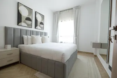 a bedroom with a large bed and a window at Designer Furnished Villa with Luxury Finishes in Springs 14 in Dubai