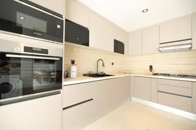 a kitchen with white cabinets and a sink at Designer Furnished Villa with Luxury Finishes in Springs 14 in Dubai