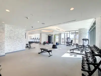 a gym with rows of treadmills and exercise bikes at Vogue Emaar Beach Front Marina Vista near JBR and Palm Jumeirah, Two Bedroom Apartment with Balcony and Private Beach, Access to all Amenities in Dubai
