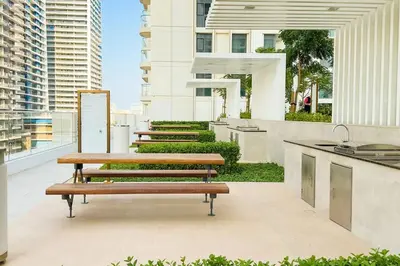 a group of benches sitting on top of a building at Vogue Emaar Beach Front Marina Vista near JBR and Palm Jumeirah, Two Bedroom Apartment with Balcony and Private Beach, Access to all Amenities in Dubai