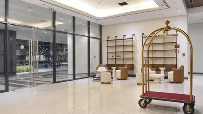 a salon with a waiting room with a luggage cart at New Modern Japanese Style Studio by Downtown in Dubai