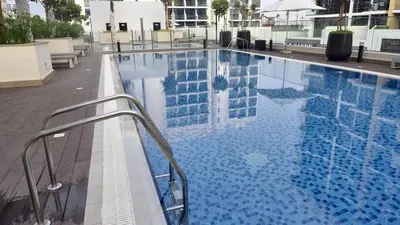 a large swimming pool on top of a building at New Modern Japanese Style Studio by Downtown in Dubai