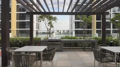 a patio with tables and chairs and a grill at New Modern Japanese Style Studio by Downtown in Dubai