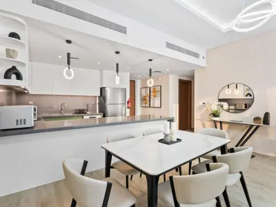 a kitchen and dining room with a table and chairs at Modern Serenity Central Park 2BR Escape-51 in Dubai