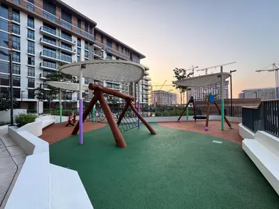 a playground with a swing set on a building at Modern Serenity Central Park 2BR Escape-51 in Dubai