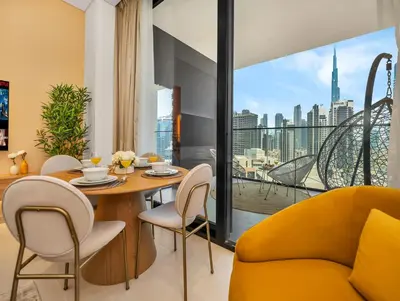 a dining room with a table and chairs and a large window at Premium Burj Khalifa View & Private Jacuzzi in Dubai