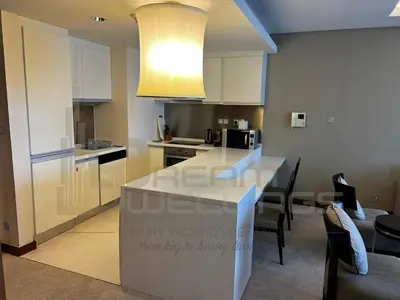 a kitchen with a white counter top in a room at Kempinski Central Avenue One Bedroom in Dubai