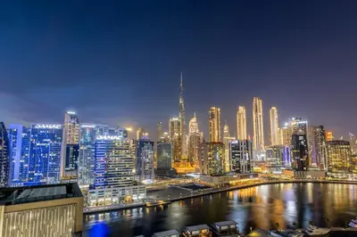 a view of a large city at night at Waves - Premium 1BR Apartment Overlooking Burj Khalifa in Dubai