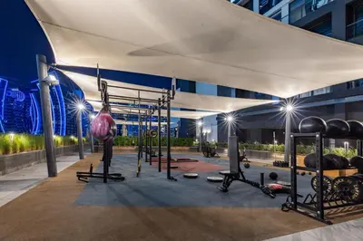 a fitness room with a gym with weights at Waves - Premium 1BR Apartment Overlooking Burj Khalifa in Dubai