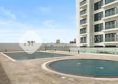 a swimming pool in front of a building at Bloomfields Cozy Stu in Alexis Tower in Dubai