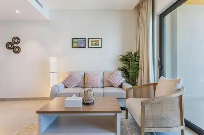 a living room with a couch and a table at STAY BY LATINEM Luxury 1BR Holiday Home WG2809 Near Burj Khalifa in Dubai