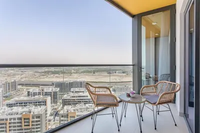 a balcony with chairs and a table and a view at STAY BY LATINEM Luxury 1BR Holiday Home WG2809 Near Burj Khalifa in Dubai