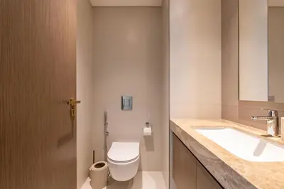 a bathroom with a toilet and a sink at Designer 2-BR - Sea View - Grand Bleu by Elie Saab in Dubai