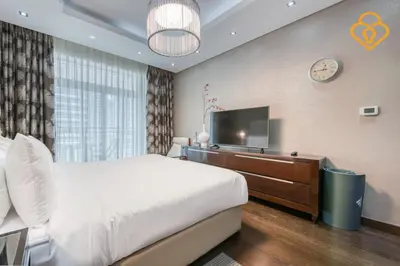 a bedroom with a bed and a flat screen tv at Keysplease Upgraded 1 BR Apt near Dubai Mall, Burj Views in Dubai