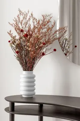 a white vase sitting on a table with a lamp at Palm-View 2BR Elie Saab Luxury in Dubai