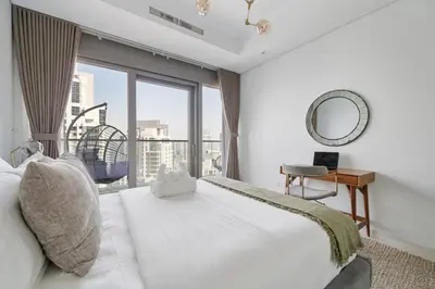 a bedroom with a large bed and a large window at Sky-High Infinity Pool with Burj Khalifa Views in Dubai