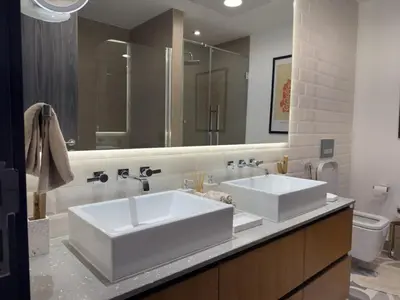a bathroom with two sinks and a large mirror at Elite Turnkey Residence 2BR in OIA Motor City 237 Dubai in Dubai