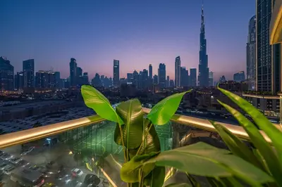 a plant on a balcony with a city skyline at & Burj Luxury Living 2bhk Direct Burj Khalifa View in Dubai