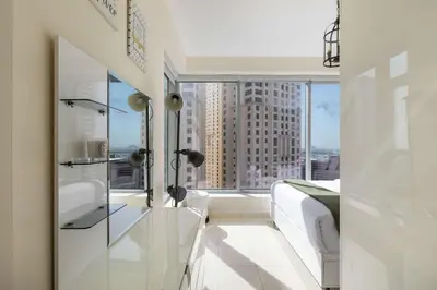 a bedroom with a bed and a large window at Beautiful Marina Views 1 Bed in Dubai