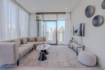 a living room with a couch and a table at TRPS - Peninsula Five, Business Bay - Stylish 1BR - Canal & Burj Khalifa Views in Dubai