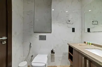 a bathroom with a toilet and a sink at Modern Apartment with Canal Views, Near Dubai Mall and Burj Khalifa in Dubai