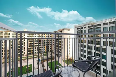 a balcony with chairs and a view of buildings at The Gifted Cozy Home in Dubai