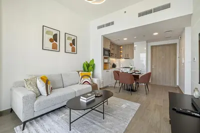 a living room with a couch and a table at The Queens Tranquil Oasis 1BDR in Dubai