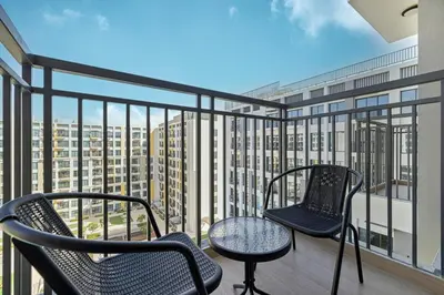 two chairs and a table on a balcony at The Queens Tranquil Oasis 1BDR in Dubai