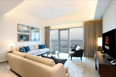a living room with a couch and a table at Livbnb - Premium 3BR with Burj Skyline View in Dubai