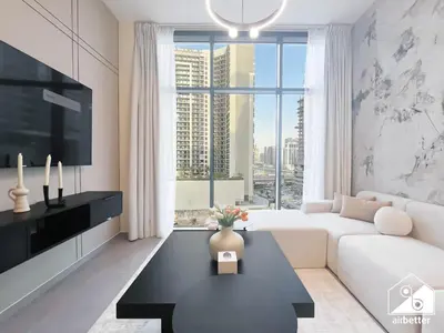 a living room with a white couch and a large window at Luxury 2BR in Merano Tower Panoramic City Views in Dubai