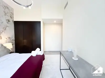a bedroom with a bed with a purple blanket at Luxury 2BR in Merano Tower Panoramic City Views in Dubai